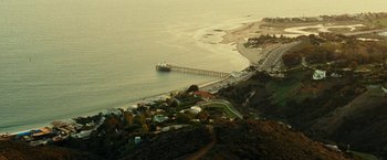 Movie still from “Taken 3” (2014), directed by Olivier Megaton – An aerial view of a beach and a pier; Extreme Wide shot, High angle