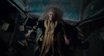 Movie still from “Only Lovers Left Alive” (2013), directed by Jim Jarmusch – A woman with long blonde hair laying on the ground; Medium shot, Overhead angle