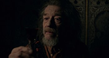 Movie still from “Only Lovers Left Alive” (2013), directed by Jim Jarmusch – An older man with long grey hair holding a glass of wine; Close Up shot, Over the shoulder angle