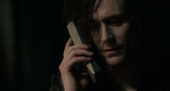 Movie still from “Only Lovers Left Alive” (2013), directed by Jim Jarmusch – A man holding a cell phone up to his ear; Close Up shot, High angle