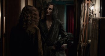 Movie still from “Only Lovers Left Alive” (2013), directed by Jim Jarmusch – A man with long hair standing in front of a mirror; Medium shot, Over the shoulder angle