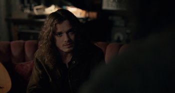 Movie still from “Only Lovers Left Alive” (2013), directed by Jim Jarmusch – A man with long hair sitting on a couch; Close Up shot, Over the shoulder angle