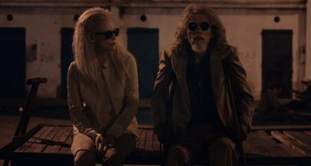 Movie still from “Only Lovers Left Alive” (2013), directed by Jim Jarmusch – A man and a woman sitting next to each other on a bench; Medium shot, Over the shoulder angle