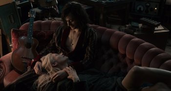 Movie still from “Only Lovers Left Alive” (2013), directed by Jim Jarmusch – Two women sitting on a couch in a living room; Medium shot, Overhead angle