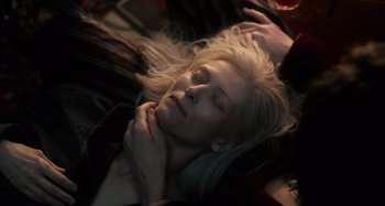 Movie still from “Only Lovers Left Alive” (2013), directed by Jim Jarmusch – A woman laying on the ground with her eyes closed; Close Up shot, Overhead angle