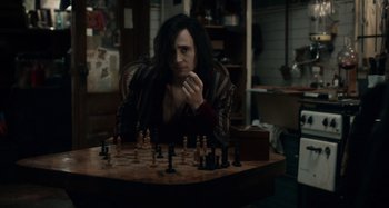 Movie still from “Only Lovers Left Alive” (2013), directed by Jim Jarmusch – A man sitting at a table playing a game of chess; Medium shot, High angle