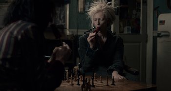 Movie still from “Only Lovers Left Alive” (2013), directed by Jim Jarmusch – Two people sitting at a table playing a game of chess; Medium shot, Over the shoulder angle