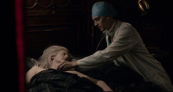 Movie still from “Only Lovers Left Alive” (2013), directed by Jim Jarmusch – A doctor examining a patient with a stethoscope; Medium shot, High angle