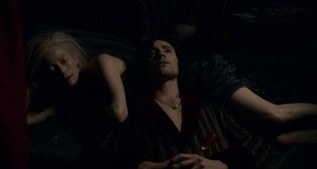 Movie still from “Only Lovers Left Alive” (2013), directed by Jim Jarmusch – A man and a woman sitting next to each other in a dark room; Medium shot, Overhead angle