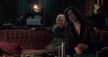 Movie still from “Only Lovers Left Alive” (2013), directed by Jim Jarmusch – A woman sitting on a couch next to a man; Medium shot, High angle