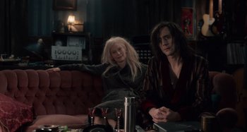 Movie still from “Only Lovers Left Alive” (2013), directed by Jim Jarmusch – A woman sitting on a couch next to a man in a bathrobe; Medium shot, High angle