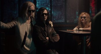 Movie still from “Only Lovers Left Alive” (2013), directed by Jim Jarmusch – A man and a woman sitting at a table in front of a window; Medium shot, Low angle