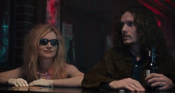 Movie still from “Only Lovers Left Alive” (2013), directed by Jim Jarmusch – A man and a woman sitting at a table in a room; Medium shot, Low angle