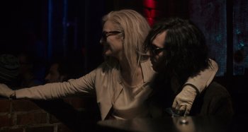 Movie still from “Only Lovers Left Alive” (2013), directed by Jim Jarmusch – Two women sitting at a table in front of each other; Medium shot, Over the shoulder angle