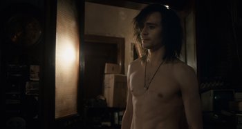 Movie still from “Only Lovers Left Alive” (2013), directed by Jim Jarmusch – A shirtless man standing in front of a window; Medium shot, Over the shoulder angle