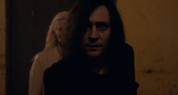 Movie still from “Only Lovers Left Alive” (2013), directed by Jim Jarmusch – A person with long black hair; Close Up shot, Over the shoulder angle