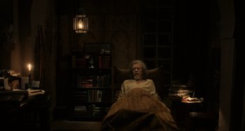 Movie still from “Only Lovers Left Alive” (2013), directed by Jim Jarmusch – An old man laying in a bed in a dark room; Wide shot, High angle