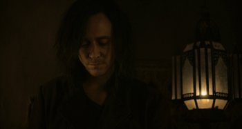 Movie still from “Only Lovers Left Alive” (2013), directed by Jim Jarmusch – A man with long hair is looking down at his face; Close Up shot, Over the shoulder angle
