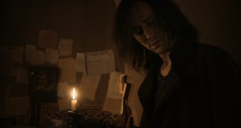 Movie still from “Only Lovers Left Alive” (2013), directed by Jim Jarmusch – A man with long dark hair standing in front of a candle; Medium shot, Low angle