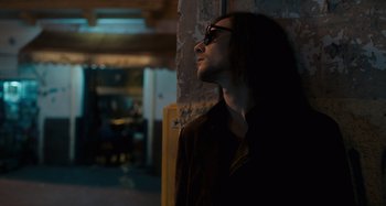Movie still from “Only Lovers Left Alive” (2013), directed by Jim Jarmusch – A man with long black hair wearing glasses looking up; Close Up shot, Low angle