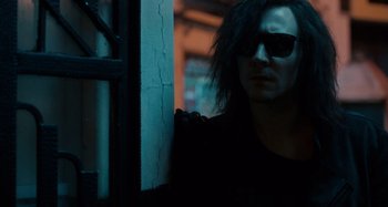 Movie still from “Only Lovers Left Alive” (2013), directed by Jim Jarmusch – A man with long black hair wearing sunglasses; Close Up shot, Over the shoulder angle