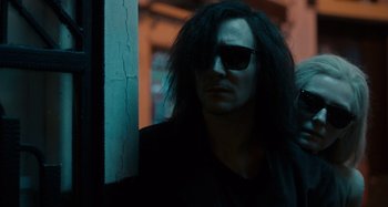 Movie still from “Only Lovers Left Alive” (2013), directed by Jim Jarmusch – A man with long black hair wearing sunglasses; Medium shot, Over the shoulder angle