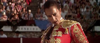 Movie still from “Talk to Her” (2002), directed by Pedro Almodóvar – A person wearing a red and gold uniform; Close Up shot, Low angle