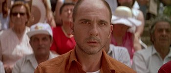 Movie still from “Talk to Her” (2002), directed by Pedro Almodóvar – A person with a crowd of people in the background; Close Up shot, Low angle