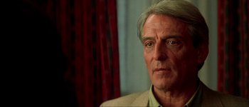 Movie still from “Talk to Her” (2002), directed by Pedro Almodóvar – An older man in a tan jacket looking at the camera; Close Up shot, Over the shoulder angle