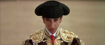 Movie still from “Talk to Her” (2002), directed by Pedro Almodóvar – A man wearing a black hat and a red tie; Close Up shot, Low angle