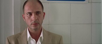 Movie still from “Talk to Her” (2002), directed by Pedro Almodóvar – A person wearing a suit and tie; Close Up shot, Low angle