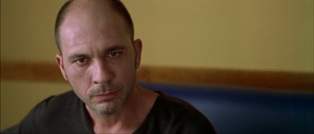 Movie still from “Talk to Her” (2002), directed by Pedro Almodóvar – A person wearing a black t - shirt; Close Up shot, Low angle