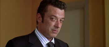 Movie still from “Talk to Her” (2002), directed by Pedro Almodóvar – A person wearing a suit and tie; Close Up shot, Low angle