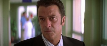 Movie still from “Talk to Her” (2002), directed by Pedro Almodóvar – A person wearing a suit and tie; Close Up shot, Low angle