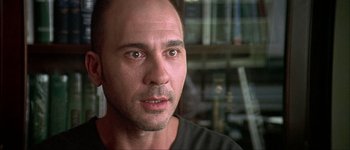 Movie still from “Talk to Her” (2002), directed by Pedro Almodóvar – A person wearing a black t - shirt; Close Up shot, Low angle