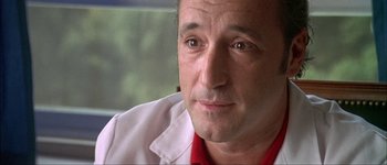 Movie still from “Talk to Her” (2002), directed by Pedro Almodóvar – A person wearing a white shirt; Close Up shot, Low angle