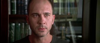 Movie still from “Talk to Her” (2002), directed by Pedro Almodóvar – A person wearing a black t - shirt; Close Up shot, Low angle