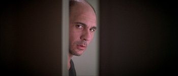 Movie still from “Talk to Her” (2002), directed by Pedro Almodóvar – A man with a bald head is looking out a window; Close Up shot, Low angle