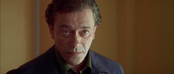 Movie still from “Talk to Her” (2002), directed by Pedro Almodóvar – A person wearing a green shirt; Close Up shot, Over the shoulder angle