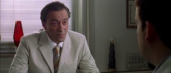 Movie still from “Talk to Her” (2002), directed by Pedro Almodóvar – A person wearing a suit and tie; Close Up shot, Over the shoulder angle