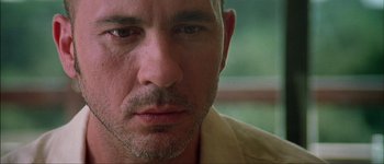 Movie still from “Talk to Her” (2002), directed by Pedro Almodóvar – A man's face in a yellow shirt; Extreme Close Up shot, Low angle