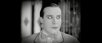 Movie still from “Talk to Her” (2002), directed by Pedro Almodóvar – A black and white photo of a man with a bow tie; Close Up shot, Over the shoulder angle