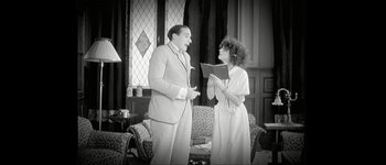 Movie still from “Talk to Her” (2002), directed by Pedro Almodóvar – A man and a woman are standing in a living room; Medium shot, Low angle