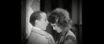 Movie still from “Talk to Her” (2002), directed by Pedro Almodóvar – A man and a woman standing next to each other; Medium shot, Low angle