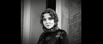 Movie still from “Talk to Her” (2002), directed by Pedro Almodóvar – An old photo of a woman in a black dress; Close Up shot, Over the shoulder angle