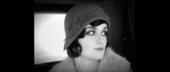 Movie still from “Talk to Her” (2002), directed by Pedro Almodóvar – A woman wearing a cloche hat with a flower on it's brim; Close Up shot, Low angle