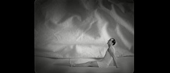 Movie still from “Talk to Her” (2002), directed by Pedro Almodóvar – A man is doing a yoga pose on the ground; Wide shot, Overhead angle