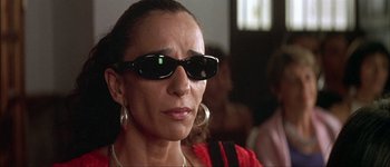 Movie still from “Talk to Her” (2002), directed by Pedro Almodóvar – A person wearing sunglasses; Close Up shot, Low angle