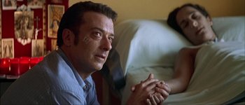 Movie still from “Talk to Her” (2002), directed by Pedro Almodóvar – A person sitting on a couch; Close Up shot, Low angle