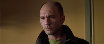 Movie still from “Talk to Her” (2002), directed by Pedro Almodóvar – A man with a bald head wearing a green shirt; Close Up shot, Low angle